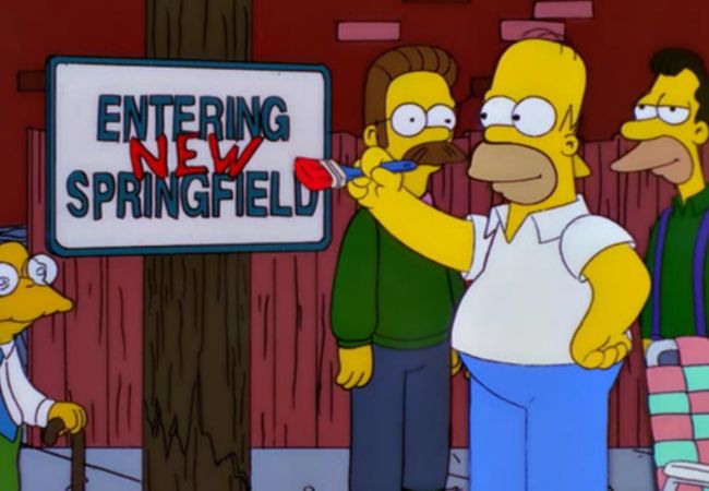Homer schreibt ein Ortsschild mit Entering New Springfield.